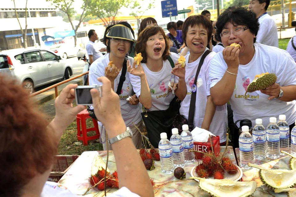 Eating durian at a Malaysian roadside stall
