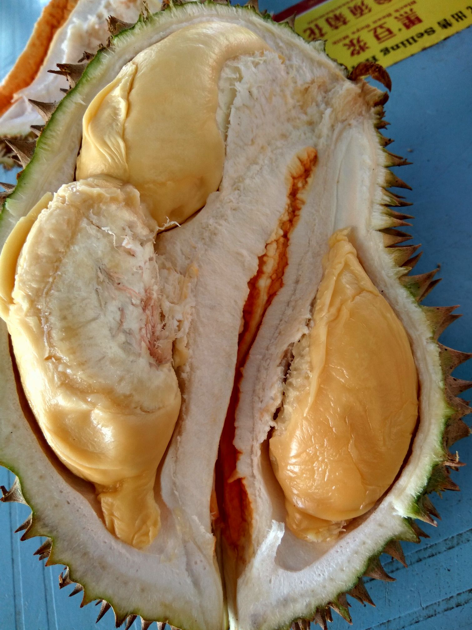 Buluh Bawah opened durian showing thick orange flesh
